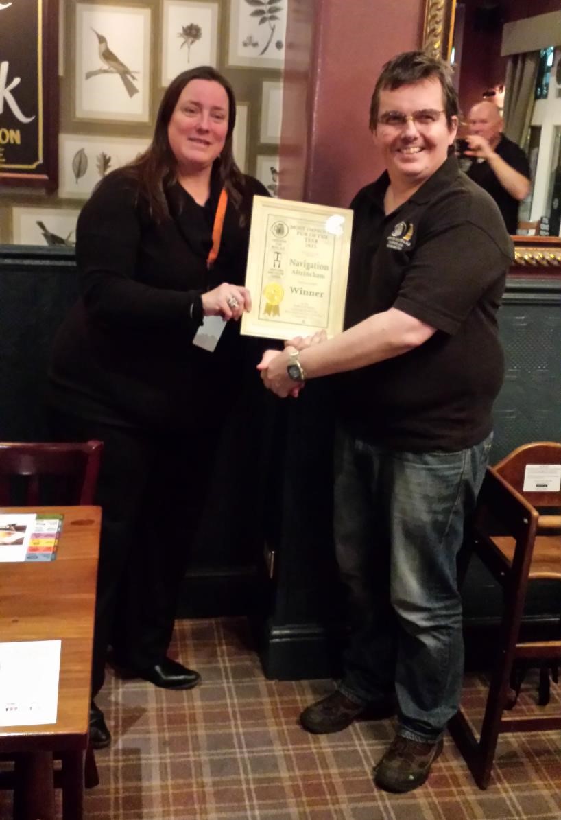 Julie accepting the award from John